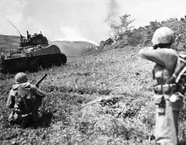Flame-throwing tank and U. S. Marines rifleman moving up to the front lines during the Battle of Okinawa, 11 May 1945