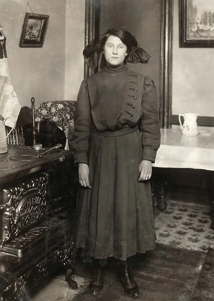GIRL, c1910. A 14-year-old girl photographed by Lewis Hine, at her home in New York City