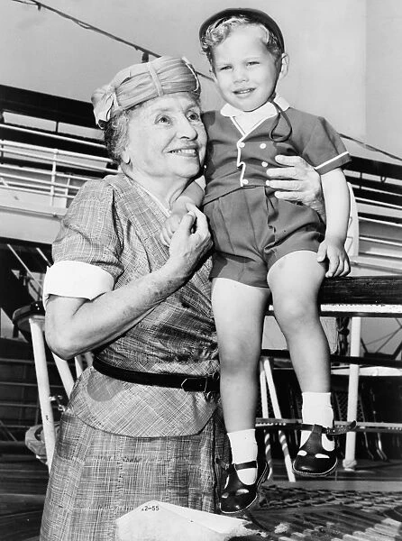 HELEN ADAMS KELLER (1880-1968). American writer and lecturer. Helen Keller with two-year-old Donald Hart on board the ocean liner Independence, after the ship docked in New York City. Photograph by Ed Ford, c1956