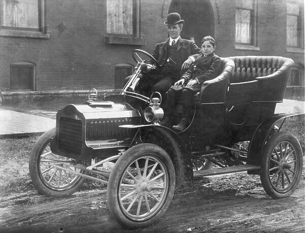 HENRY FORD (1863-1947) with his son Edsel in a 1905 Model F Ford in front of their