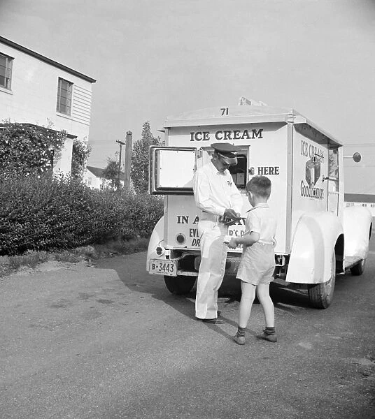 ICE CREAM MAN, 1942. Children buying ice cream from the Good Humor man in Greenbelt, Maryland