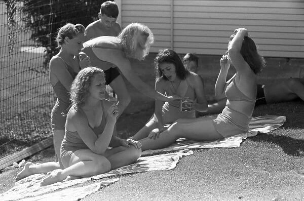 IDAHO: SUN BATHERS, 1941. Sun bathers applying olive oil at the public swimming pool park, Caldwell, Idaho. Photograph by Russell Lee, July 1941