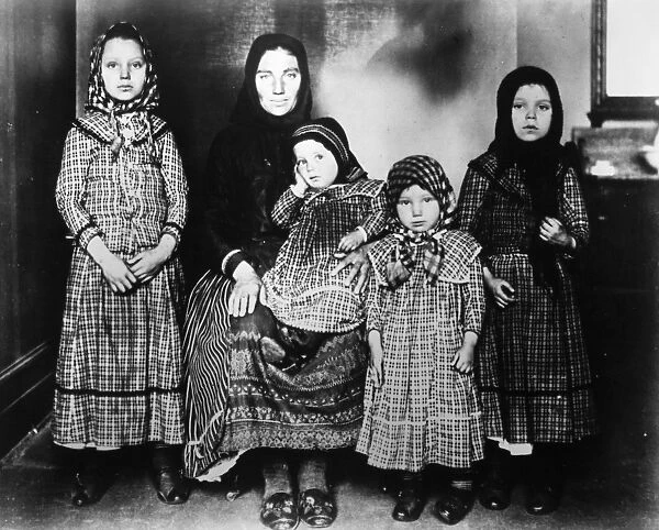 IMMIGRANTS: ELLIS ISLAND. An immigrant mother and her children at Ellis Island, c1900