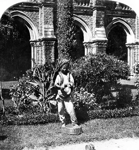 INDIA: SNAKE CHARMER, c1901. A young snake charmer in Bombay (now Mumbai), India