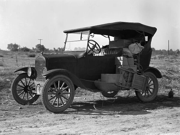 MIGRANT AUTOMOBILE, 1936. An automobile carrying the belongings of a migrant worker