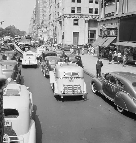 NYC: FIFTH AVENUE, 1939. Traffic on 5th Avenue near 57th Street in New York City