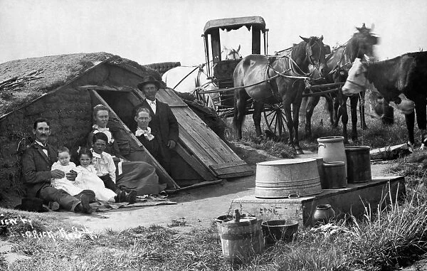 OKLAHOMA DUGOUT, c1909. A family in front of their dugout house with a horse-drawn wagon