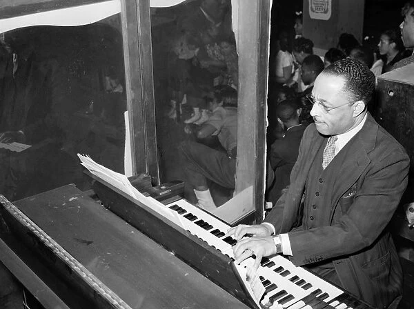 ORGANIST, 1941. The organist at an African American rollerskating rink in Chicago, Illinois