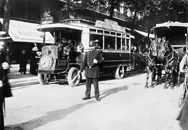 PARIS: OMNIBUS, c1920. A policeman directs traffic on a Parisian boulevard. Photograph