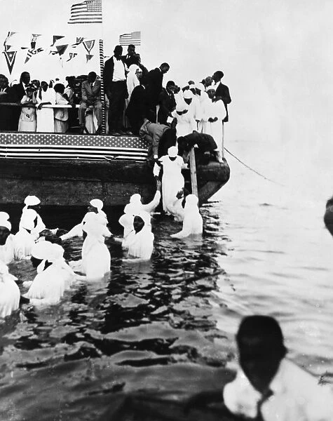 RIVER BAPTISM, c1925. Men and women being baptised in the James River in Virginia