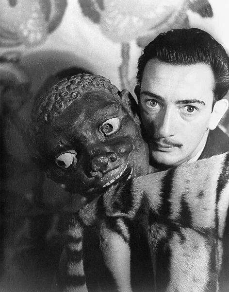 SALVADOR DALI (1904-1989). Spanish painter. Photographed by Carl Van Vechten, with a carved mask