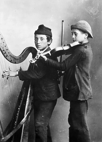 STREET MUSICIANS, 1891. Young Chicago street musicians. Photographed in 1891
