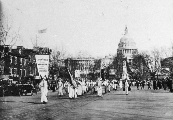 SUFFRAGE PARADE, 1913. Marchers carrying a banner reading Countries Where Women