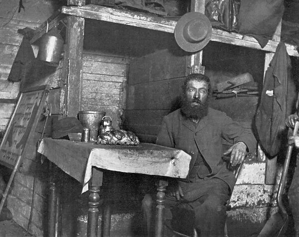 TENEMENT LIFE, c1890. A Jewish cobbler preparing for Sabbath Eve in a Ludlow Street coal cellar