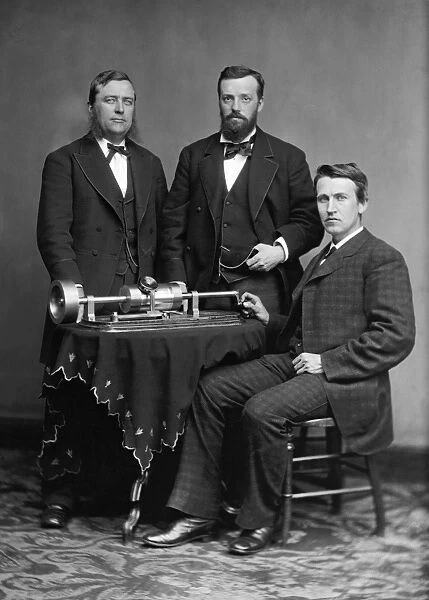 THOMAS EDISON (1847-1931). American inventor. Photographed with collegues and his phonograph