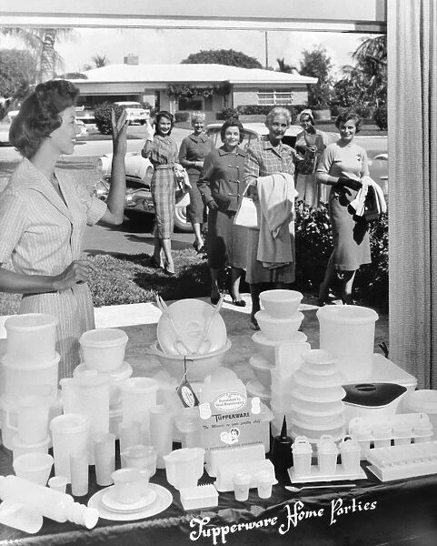 TUPPERWARE PARTY, 1950s. Women arriving for a Tupperware party in an American suberban home. Advertising photograph, 1950s