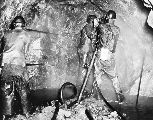 ZAMBIA: COPPER MINE. Mine workers drilling charge holes for blasting in the Roan Antelope Copper Mine in Northern Rhodesia (now Zambia), 1955