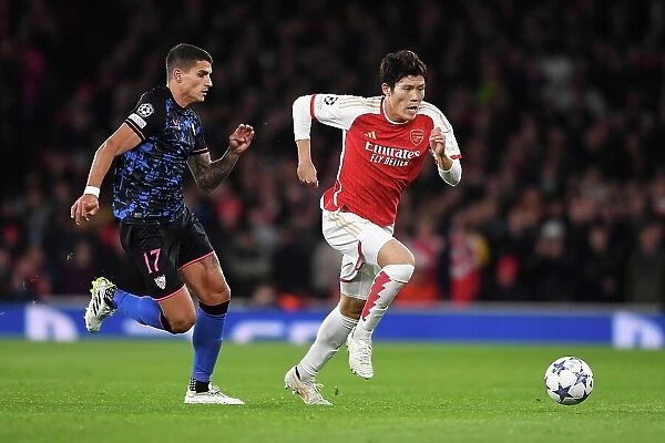 Arsenal vs Sevilla: Battle in Group B - Arsenal's Tomiyasu Outruns Lamela in the UEFA Champions League 2023 / 24