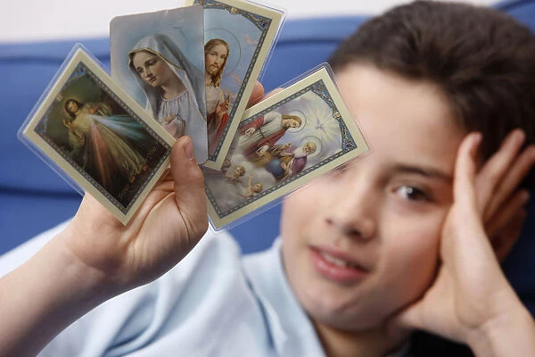 Boy holding religious images
