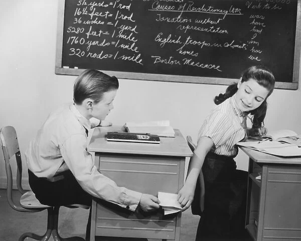 Children exchanging notes during class, 1950s-60s