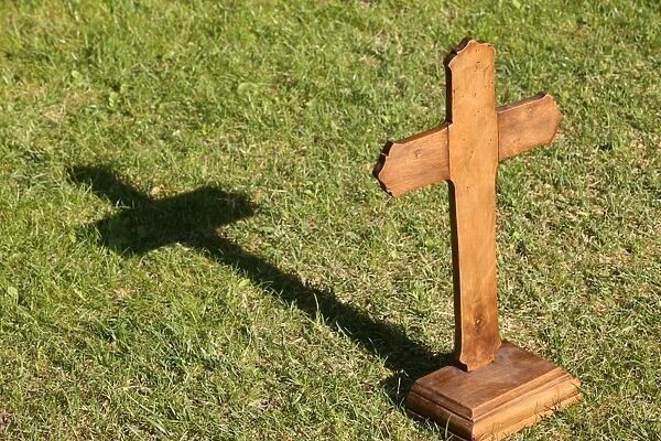 Christian cross on grass