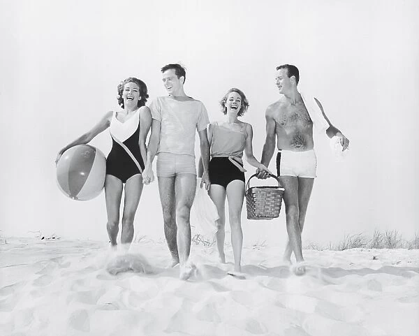 Two couples walking on beach