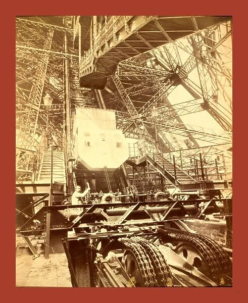 Eiffel Tower Machinery With A Man Beside The Wheel That Raises Elevator