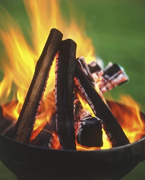 Firewood burning in barbecue grill