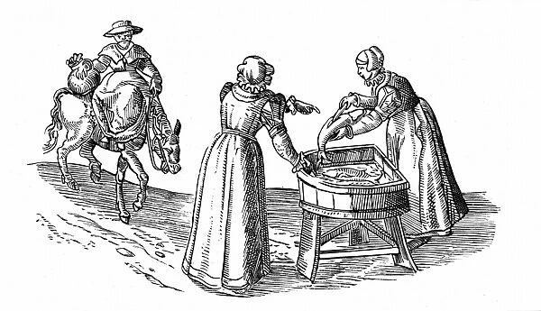 Fish stall in a market: Woman guts a fish while her companion drums up custom. Third