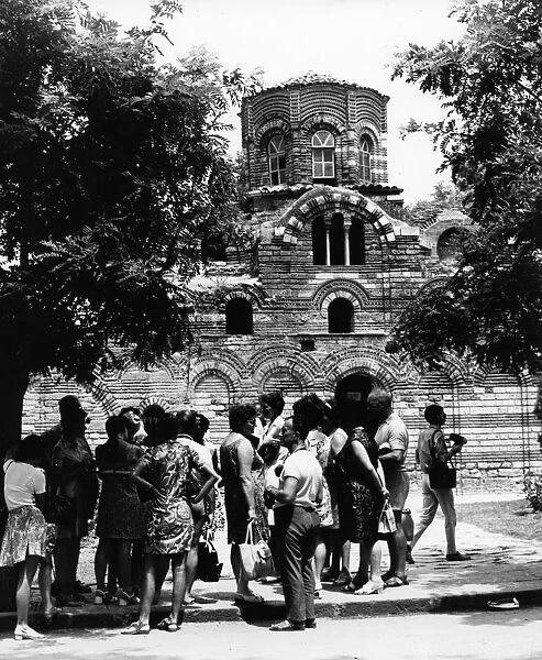 A group of foreign tourists visiting a medieval church in nessebre, bulgaria, 1974