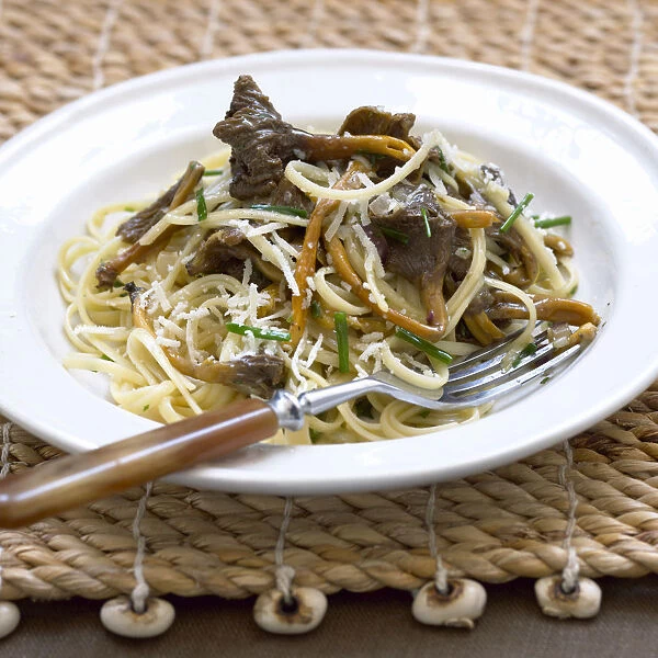 Linguini pasta with trumpet chanterelle mushrooms and grated cheese