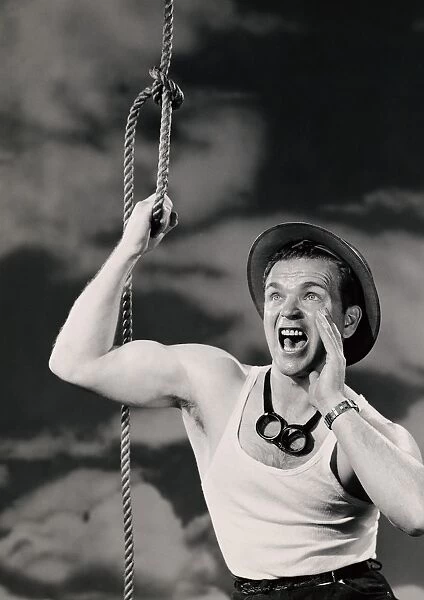 Man holding onto rope and shouting