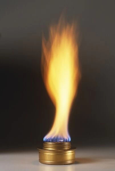 Natural gas burner and large orange and blue flame, close-up