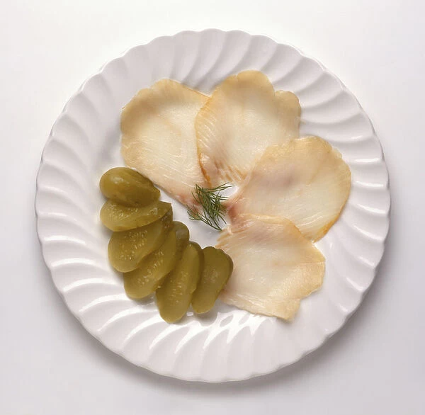 Osetrina, slices of sturgeon and gherkins, a traditional Russian dish, view from above