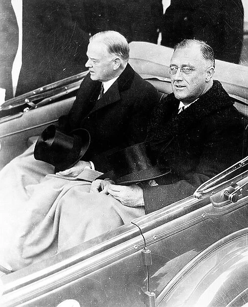 Presidents Herbert Hoover and Franklin Roosevelt ride together for the inauguration