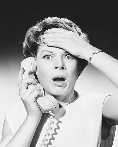 Shocked woman on telephone