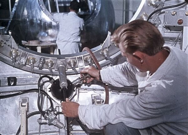 Work being done on the vostok 1 capsule in preparation for gagarins historic flight, 1961, this is a still from a soviet film about the space program