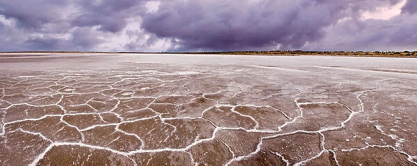 Lake Eyre. Salt patterns line small section of dry lake as storm front