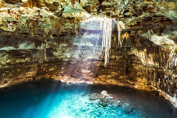 Blue Cenote with sunlight from the top, Yucatan, Mexico