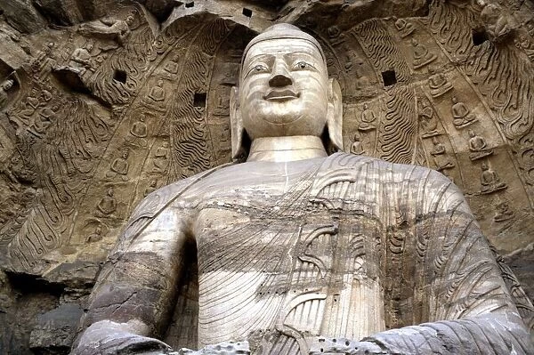 China. A Buddha statue in the ancient rock cut Yungang Buddhist temple grottoes