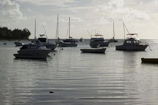 Floating dinghies at sunset in Bain Aux Boeuf, Mauritius, Africa