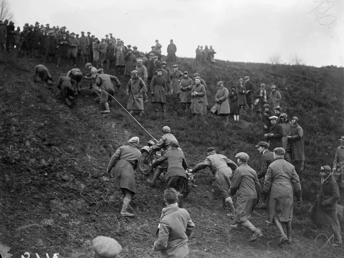 Framed Print : Pull Along March 1927 Print - A motorcyclist being pulled up a muddy slope