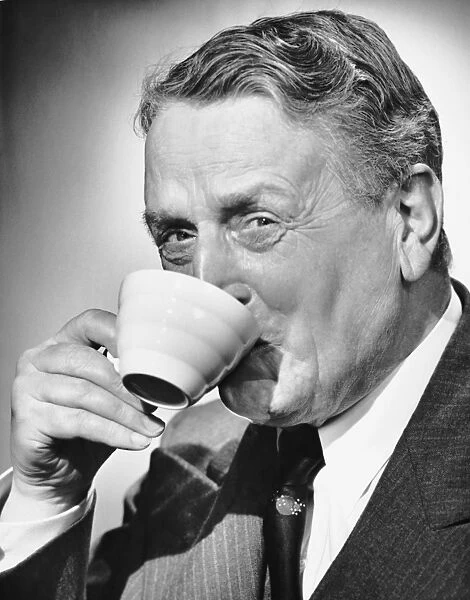 Mature man drinking cup of coffee