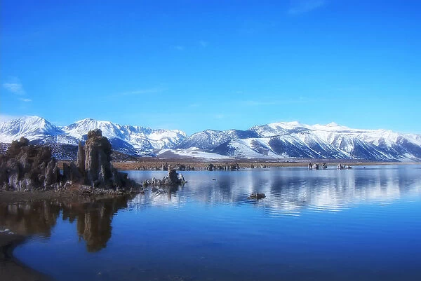 Mono lake. Clear sky over snow covering mountains with reflection on Mono lake in winter