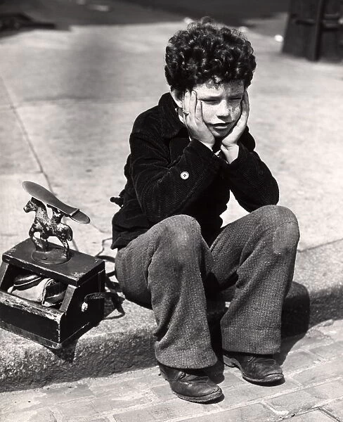 Sad Boy, Curly Hair Sitting On Curb Patched Trousers #14777557