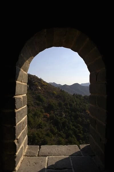 A scenic shot through a window on an outpost on the Great Wall of China