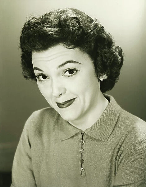 Smiling woman in studio, (B&W), close-up, portrait