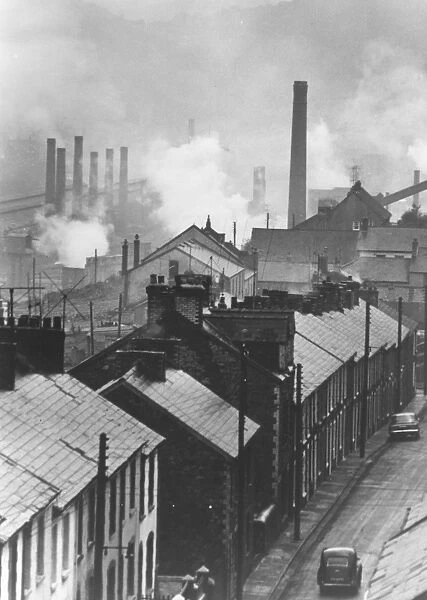 Steel Works. 18th October 1966: A row of houses with steelworks in the