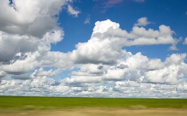 View of Cumulus Clouds Spread Over Green Fields