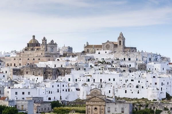 View of the town with the cathedral, right, and the church Chiesa delle Monacelle, left, Ostuni, Apulia, Italy